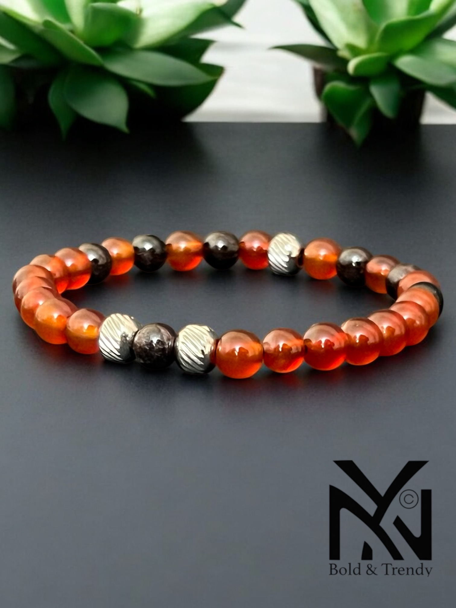 Ciel de Minuit bracelet with vibrant orange jade and black onyx, designed to promote focus and protection